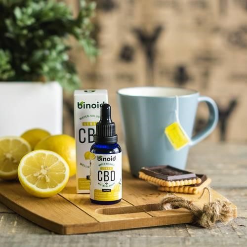 White Ceramic Mug Beside Sliced Lemon on Brown Wooden Chopping Board